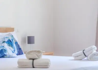 a bedroom with a bed with towels on it at Porta del Vaticano in Rome