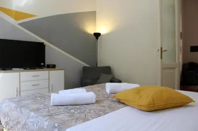 a bedroom with a bed with a yellow pillow on it at Porta del Vaticano in Rome