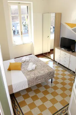 a bedroom with a large bed and a television at Porta del Vaticano in Rome