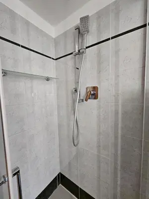a shower with a shower head in a bathroom at Be Your Home - Giulio's Apartment in Rome