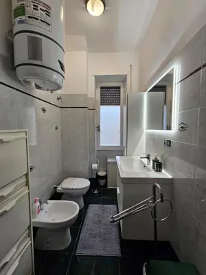a bathroom with a sink and a toilet and a sink at Be Your Home - Giulio's Apartment in Rome