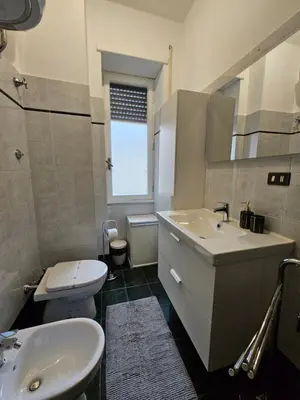 a bathroom with a sink and a toilet at Be Your Home - Giulio's Apartment in Rome
