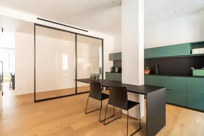 a kitchen with a black table and chairs at Popolo Design Apartment by RomeLoft in Rome