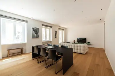 a living room with a table and a couch at Popolo Design Apartment by RomeLoft in Rome