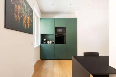 a kitchen with a green refrigerator in a room at Popolo Design Apartment by RomeLoft in Rome