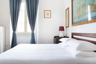 a living room with a white couch and a table at Dimora Romana - Vintage Elegance and Modern Comfort in Rome