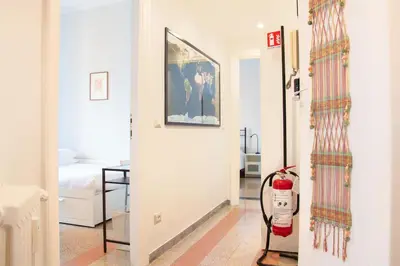 a bedroom with blue curtains next to a bed at Dimora Romana - Vintage Elegance and Modern Comfort in Rome