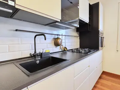 a kitchen with white cabinets and a sink at San Peter Dome Vista San Pietro in Rome