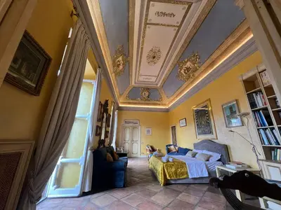 a living room with a couch and a ceiling at Antico Suites Roma in Rome