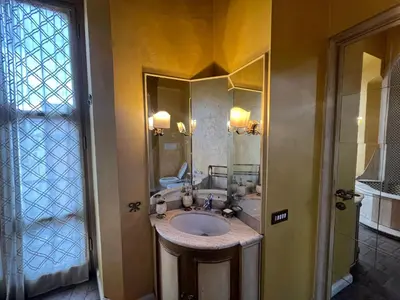 a bathroom with a sink and a mirror at Antico Suites Roma in Rome