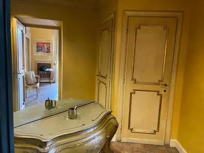 a room with a door and a suitcase at Antico Suites Roma in Rome