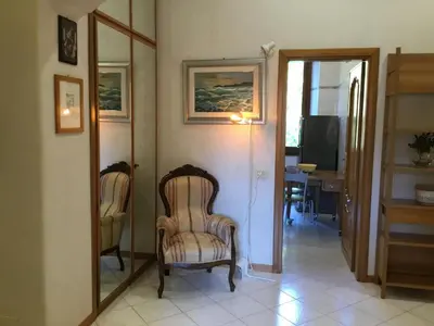 a living room with a chair and a mirror at Casa Betania in Rome