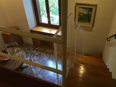 a staircase in a house with a table and a window at Casa Betania in Rome