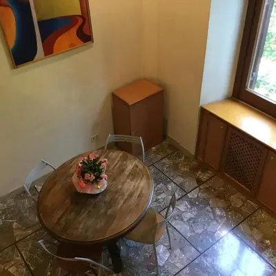 a table with flowers on it in a room at Casa Betania in Rome