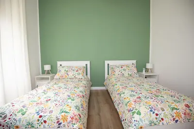 two beds sitting next to each other in a bedroom at Civico Appia Apartment in Rome