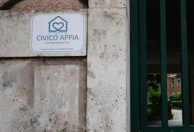 a sign on the side of a building with a window at Civico Appia Apartment in Rome