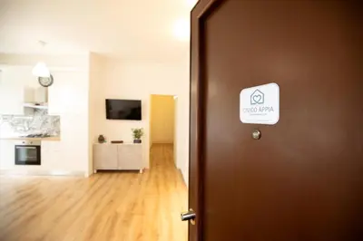 a door with a sign on it leading to a kitchen at Civico Appia Apartment in Rome