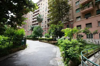 an empty street in a city with tall buildings at Civico Appia Apartment in Rome