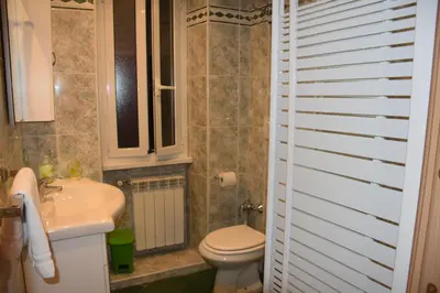 a bathroom with a white toilet and a sink at Appartamenti Romolo E Remo in Rome