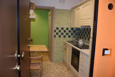 a kitchen with a sink and a table in it at Appartamenti Romolo E Remo in Rome