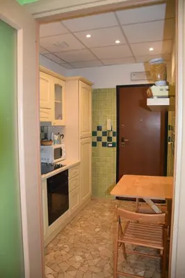 a small kitchen with a table and a microwave at Appartamenti Romolo E Remo in Rome