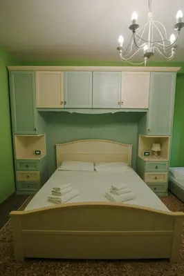 a bedroom with a large bed with green walls at Appartamenti Romolo E Remo in Rome