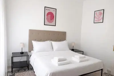a bedroom with a white bed with towels on it at Qflat Elegant Palumbo Vatican in Rome