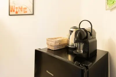 a microwave sitting on top of a black refrigerator at Qflat Elegant Palumbo Vatican in Rome
