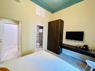 a bedroom with a flat screen tv on the wall at Aura Roma in Rome
