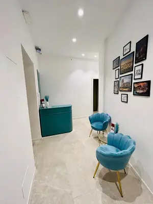 a room with two blue chairs and a counter at Aura Roma in Rome