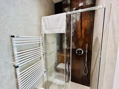 a shower with a glass door in a bathroom at Aura Roma in Rome
