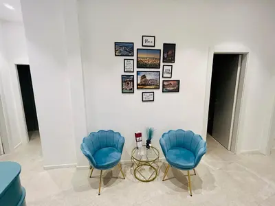 two blue chairs and a table in a room at Aura Roma in Rome