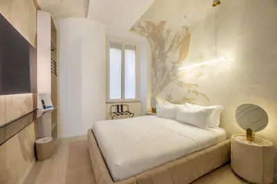 a bedroom with a bed with a tree mural on the wall at Borghese Boutique in Rome