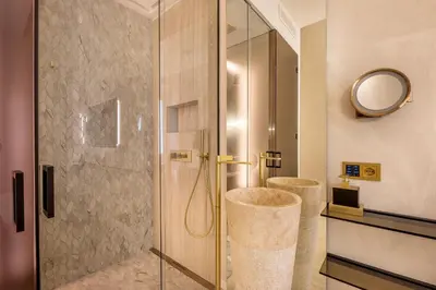 a bathroom with a shower with a glass door at Borghese Boutique in Rome