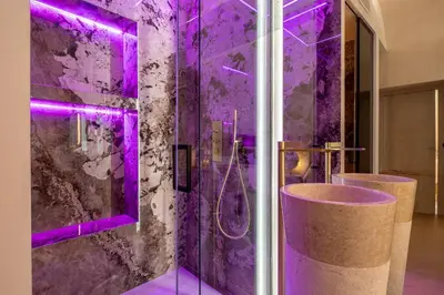 a purple bathroom with a shower with purple lighting at Borghese Boutique in Rome