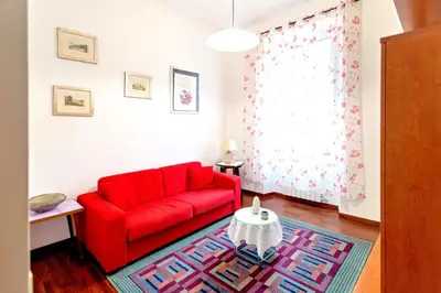 a white bedroom with a mirror and a bed at DomusVaticano in Rome