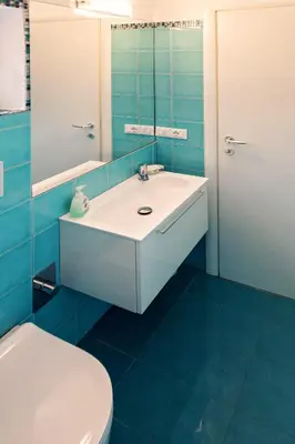 a bathroom with a shower with blue tiles at DomusVaticano in Rome