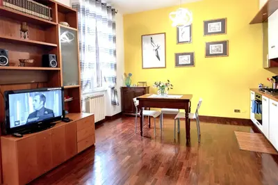 a small kitchen with white cabinets and a sink at DomusVaticano in Rome