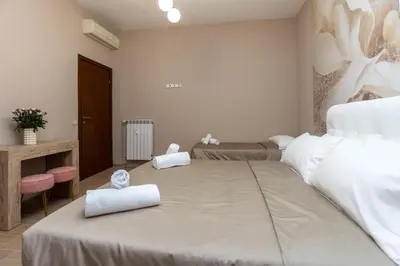 a bedroom with a large bed with two towels on it at Casa di latta in Rome