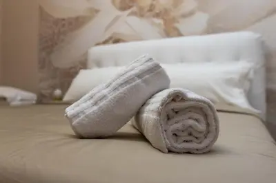 a towel sitting on top of a bed at Casa di latta in Rome