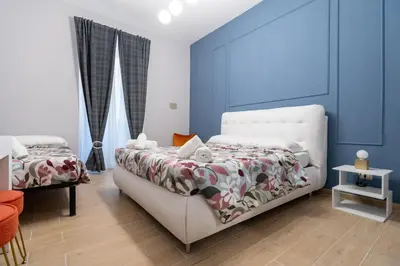 a bedroom with a white bed and blue walls at Casa di latta in Rome