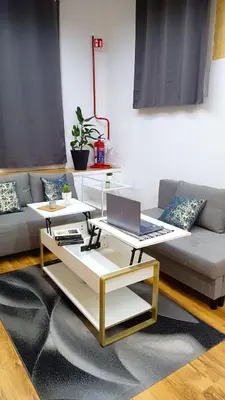 a living room with a couch and a laptop on a coffee table at Monolocale Stadio olimpico Francia Suite in Rome