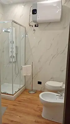 a white bathroom with a shower and a toilet at Monolocale Stadio olimpico Francia Suite in Rome