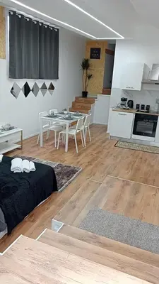 a living room with a bed and a table and a kitchen at Monolocale Stadio olimpico Francia Suite in Rome