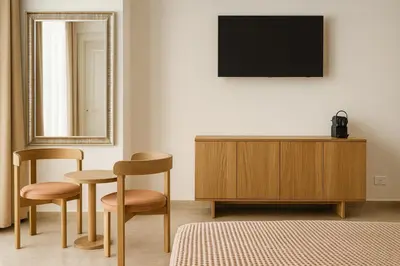 a room with two chairs and a dresser and a mirror at NERI Vatican Suite in Rome