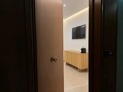 a door leading into a room with a television at NERI Vatican Suite in Rome