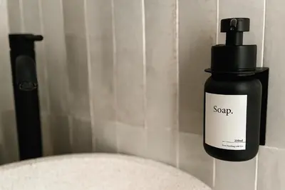 a bottle of soap sitting on the corner of a bathroom at NERI Vatican Suite in Rome