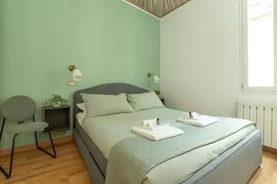 a bedroom with a bed with two towels on it at Frattina Cozy Flat Spanish Steps in Rome