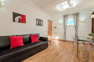 a living room with a black couch and a table at Frattina Cozy Flat Spanish Steps in Rome