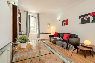 a living room with a couch and a glass table at Frattina Cozy Flat Spanish Steps in Rome